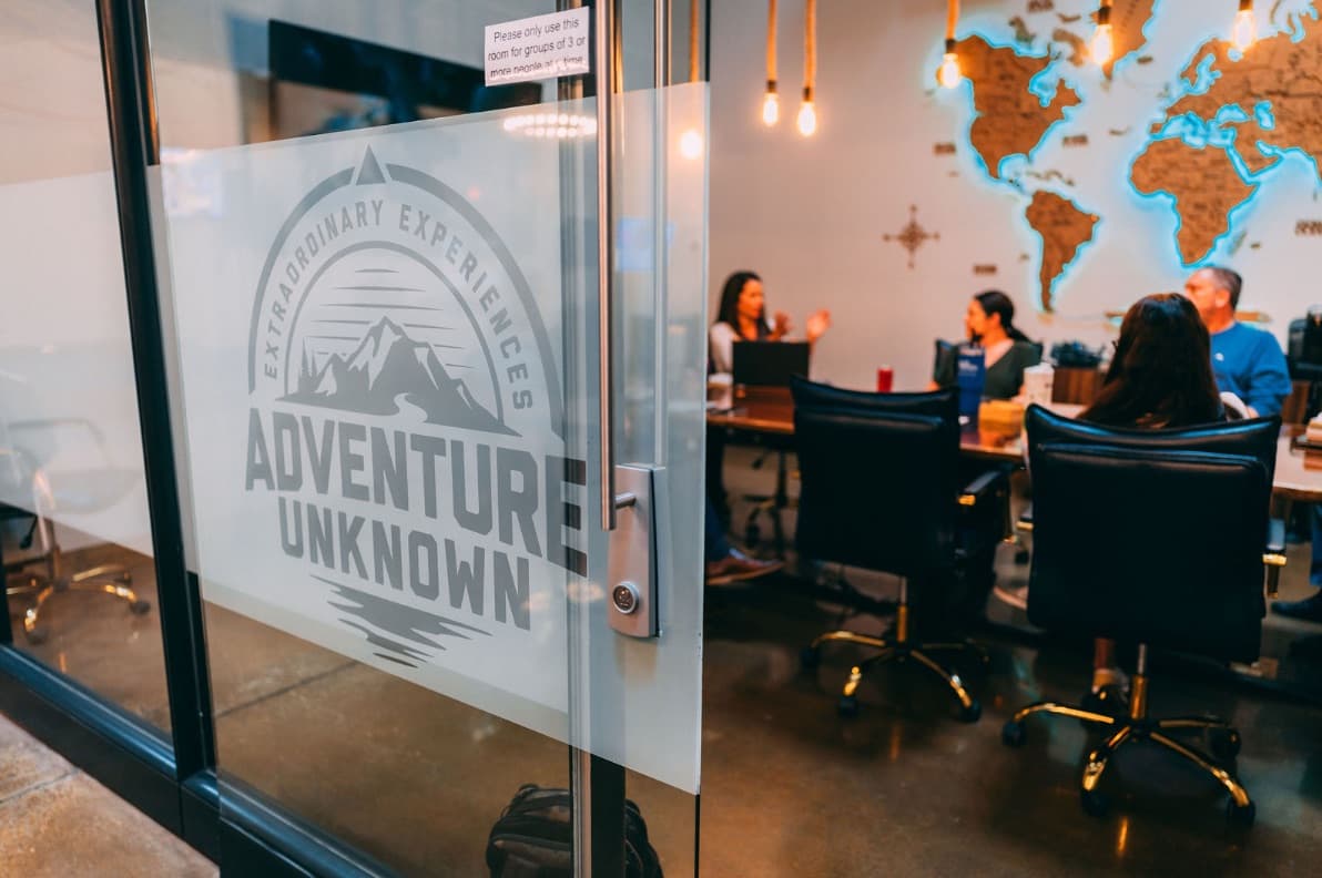 Adventure Unknown logo etched on the clubhouse entrance door