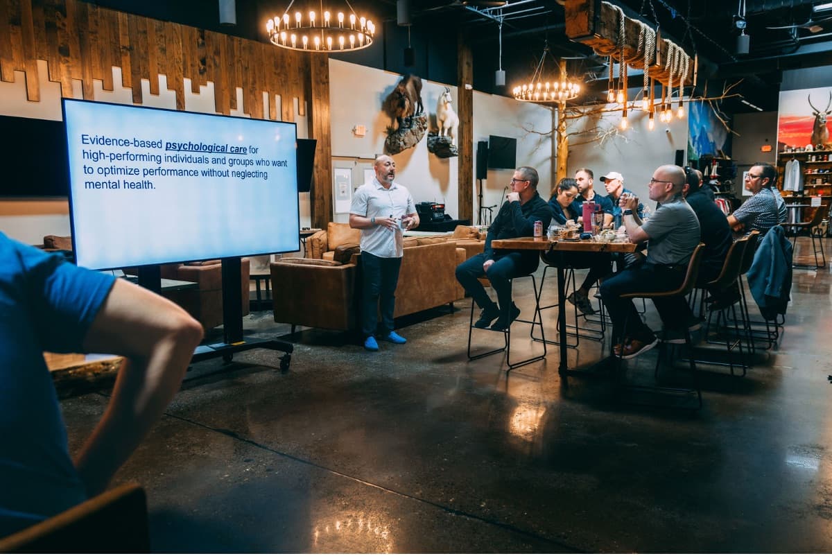 A speaker presenting to members in the clubhouse seminar space