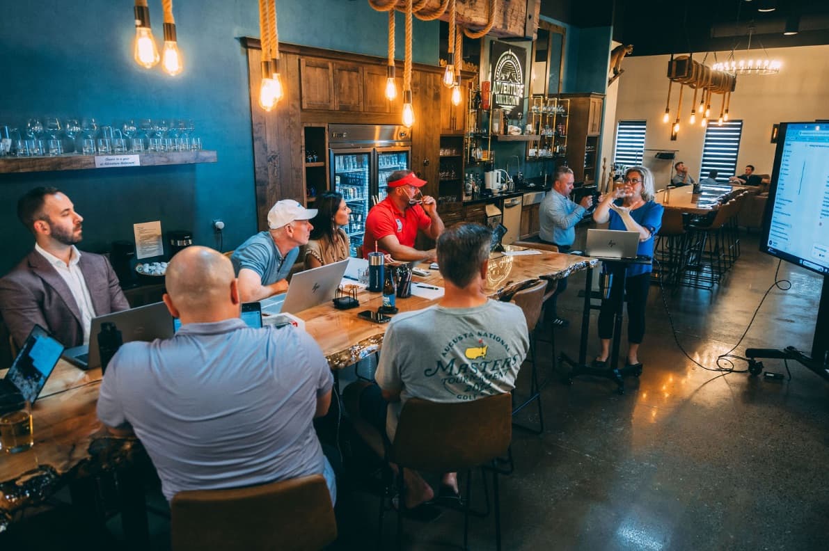 Members working and meeting at the clubhouse bar table